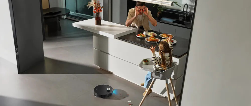 Dreame X60 Ultra robot vacuum cleans crumbs and spills off the kitchen tile.