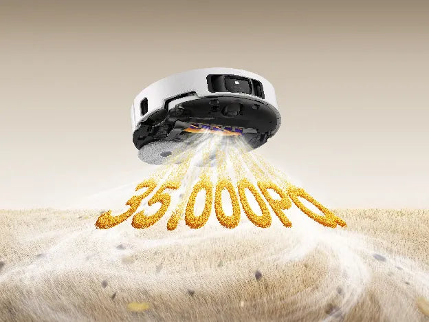 A Dreame white robot vacuum underside pulling up dust and debris, illustrating 35,000 Pa suction power.