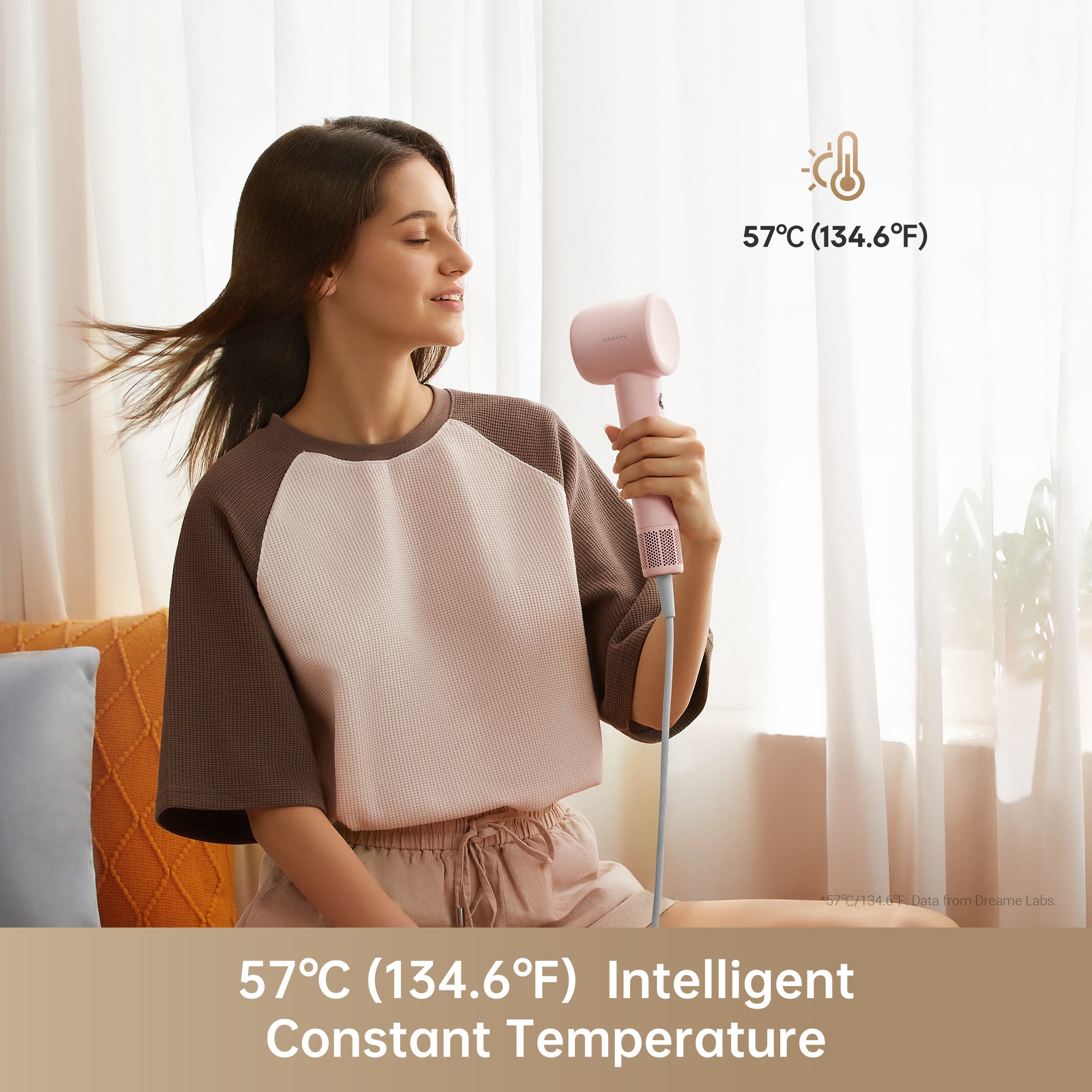 Woman using Dreame Hair Gleam hair dryer at 57°C for gentle drying.