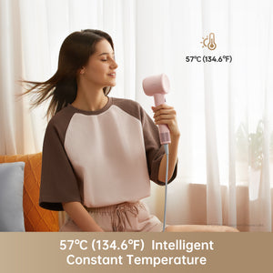 Woman using Dreame Hair Gleam hair dryer at 57°C for gentle drying.