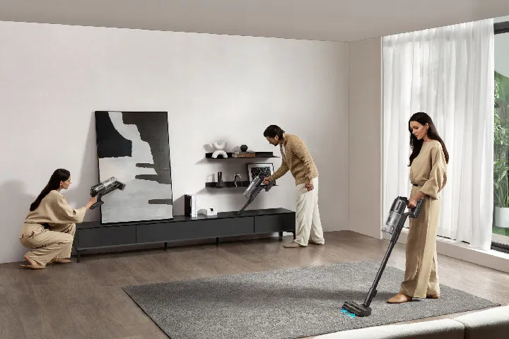 Cordless stick vacuum cleaning an open-plan floor.