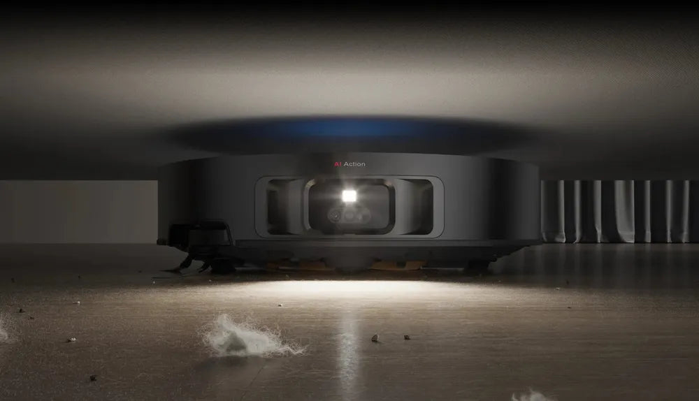 Dreame L60 Pro Ultra robot vacuum slipping under a low sofa to clear dust in the gap