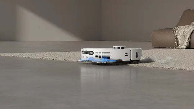 House cleaning robot vacuum cleaning along the edge where carpet meets hard floor.