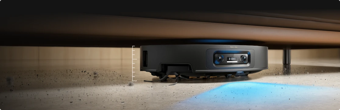 Dreame robot vacuum lighting a dim spot under furniture to reveal grit.